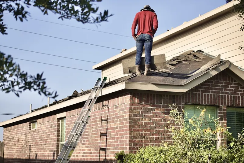 Professional roofer working on a residential roof in Bradenton Beach